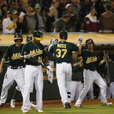Oakland Athletics Brandon Moss celebrates with teammates after hitting a solo home run during the eighth inning of their MLB American League Oakland Athletics Brandon Moss celebrates with teammates after hitting a solo home run during the eighth inning of their MLB American League