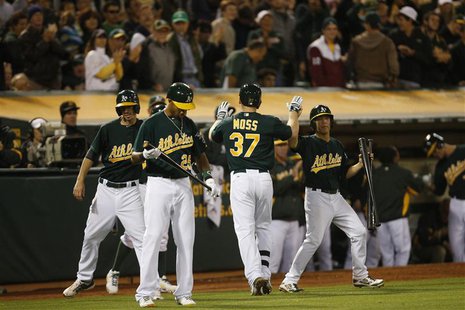 Oakland Athletics Brandon Moss celebrates with teammates after hitting a solo home run during the eighth inning of their MLB American League Oakland Athletics Brandon Moss celebrates with teammates after hitting a solo home run during the eighth inning of their MLB American League