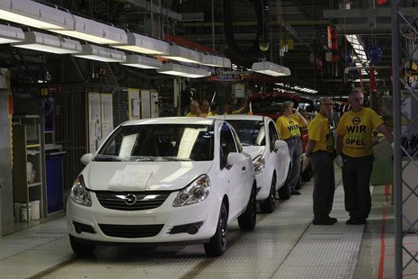 Employees of General Motors' German unit Opel stand next to an Opel Corsa at the plant in the Eastern German town of Eisenach, May 4, 2009. Employees of General Motors' German unit Opel stand next to an Opel Corsa at the plant in the Eastern German town of Eisenach, May 4, 2009.