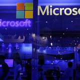 People visit the Microsoft booth at the 2013 Computex exhibition at the TWTC Nangang exhibition hall in Taipei June 4, 2013. REUTERS/Pichi C