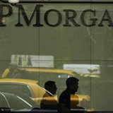 Two men walk past the front desk inside of the headquarters of JPMorgan Chase & Co bank in New York, March 15, 2013. REUTERS/Lucas Jackson