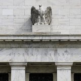 A view shows an eagle sculpture on Federal Reserve building, in Washington August 22, 2012. REUTERS/Larry Downing