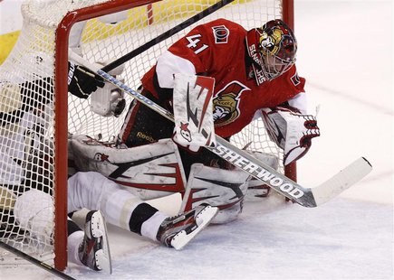 Pittsburgh Penguins' Evgeni Malkin slides into the net past Ottawa Senators goalie Craig Anderson during the first period in Game 3 of their Pittsburgh Penguins' Evgeni Malkin slides into the net past Ottawa Senators goalie Craig Anderson during the first period in Game 3 of their