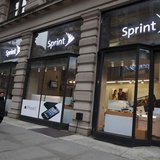 People walk past a Sprint store in New York December 17, 2012. REUTERS/Andrew Kelly