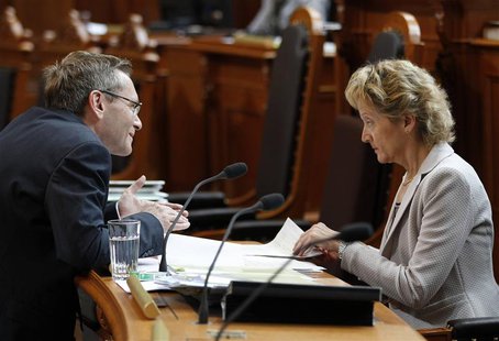Swiss Finance Minister Eveline Widmer-Schlumpf (R) talks to Councillor of State Primin Bischof during a debate on the tax agreement between Swiss Finance Minister Eveline Widmer-Schlumpf (R) talks to Councillor of State Primin Bischof during a debate on the tax agreement between