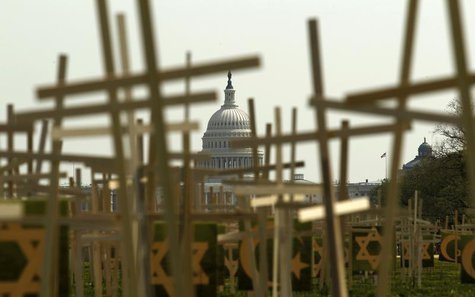 With the U.S. Capitol in the background, crosses symbolizing grave markers are placed upon the National Mall in Washington April 11, 2013. R With the U.S. Capitol in the background, crosses symbolizing grave markers are placed upon the National Mall in Washington April 11, 2013. R