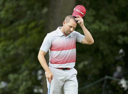 Spain's Sergio Garcia reacts after putting on the 10th green, his final hole in the first round of the 2013 U.S. Open golf championship at t Spain's Sergio Garcia reacts after putting on the 10th green, his final hole in the first round of the 2013 U.S. Open golf championship at t