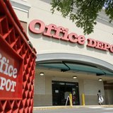 A customer leaves an Office Depot store in Arlington, Virginia July 28, 2009. REUTERS/Richard Clement