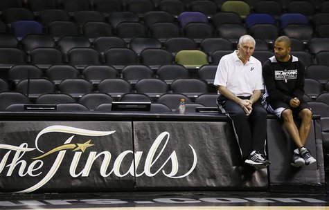 San Antonio Spurs coach Gregg Popovich (L) sits with player Tony Parker, who injured his hamstring during Game 3, during practice for their San Antonio Spurs coach Gregg Popovich (L) sits with player Tony Parker, who injured his hamstring during Game 3, during practice for their
