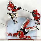 Chicago Blackhawks goalie Corey Crawford (50) makes a save on Boston Bruins left wing Kaspars Daugavins (16) during Game 1 of their NHL Stan