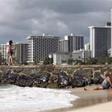 Beachgoers are pictured at Waikiki Beach in Honolulu, Hawaii November 9, 2011. (Credit: Reuters/Chris Wattie)