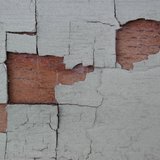 Paint chipping away on wall (courtesy of Flickr).