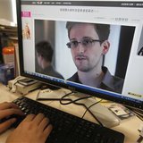 A picture of Edward Snowden, a contractor at the National Security Agency (NSA), is seen on a computer screen displaying a page of a Chinese news website, in Beijing in this June 13, 2013 photo illustration.
(Credit: Reuters/Jason Lee)