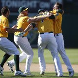 Oakland Athletics' Nate Freiman (2nd R) is congratulated by teammates after hitting the game-winning single during the 18th inning of their Oakland Athletics' Nate Freiman (2nd R) is congratulated by teammates after hitting the game-winning single during the 18th inning of their