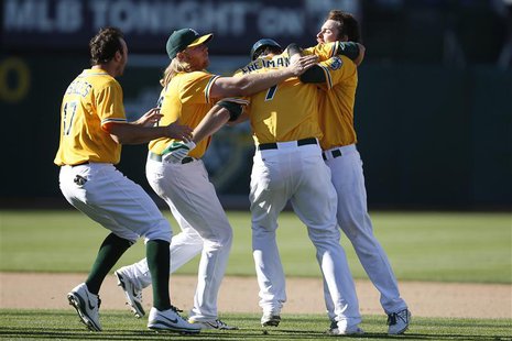 Oakland Athletics' Nate Freiman (2nd R) is congratulated by teammates after hitting the game-winning single during the 18th inning of their Oakland Athletics' Nate Freiman (2nd R) is congratulated by teammates after hitting the game-winning single during the 18th inning of their