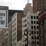 A larger banner reading "Outsource to Detroit" is seen on the side of a building on Woodward Ave in downtown Detroit, Michigan, January 7, 2