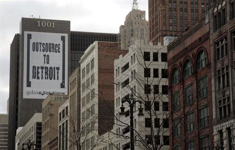 A larger banner reading "Outsource to Detroit" is seen on the side of a building on Woodward Ave in downtown Detroit, Michigan, January 7, 2 A larger banner reading "Outsource to Detroit" is seen on the side of a building on Woodward Ave in downtown Detroit, Michigan, January 7, 2