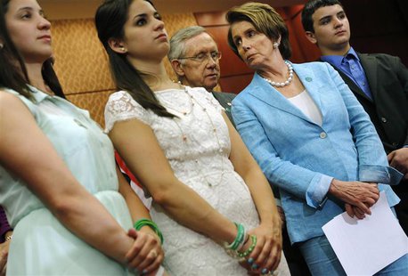 U.S. Senate Majority Leader Harry Reid (D-NV) (3rd L) and House Minority Leader Nancy Pelosi (D-CA) (2nd R) stand with Jillian Soto (L), Car U.S. Senate Majority Leader Harry Reid (D-NV) (3rd L) and House Minority Leader Nancy Pelosi (D-CA) (2nd R) stand with Jillian Soto (L), Car