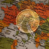 A picture illustration taken with the multiple exposure function of the camera shows a one Euro coin and a map of Europe, January 9, 2013. R
