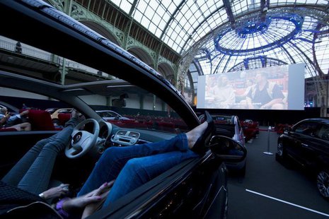 Visitors watch a film as they attend the opening night of a drive-in cinema, which will run till June 21, at the Grand Palais in Paris June Visitors watch a film as they attend the opening night of a drive-in cinema, which will run till June 21, at the Grand Palais in Paris June