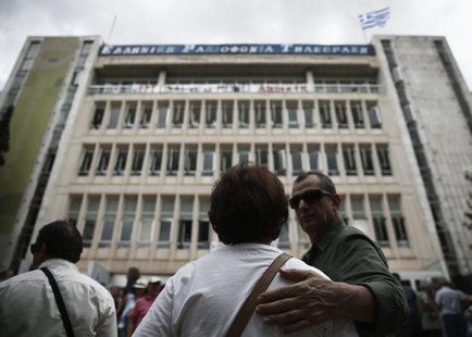 Protesters stand in front of the Greek state television ERT headquarters in Athens June 12, 2013. REUTERS/Yorgos Karahalis Protesters stand in front of the Greek state television ERT headquarters in Athens June 12, 2013. REUTERS/Yorgos Karahalis