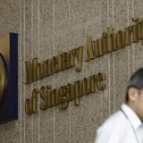 A man leaves the premises of the Monetary Authority of Singapore in the central business district of Singapore January 18, 2013. Picture tak