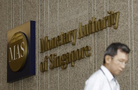 A man leaves the premises of the Monetary Authority of Singapore in the central business district of Singapore January 18, 2013. Picture tak A man leaves the premises of the Monetary Authority of Singapore in the central business district of Singapore January 18, 2013. Picture tak