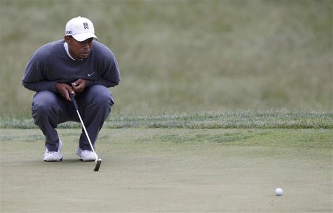 Tiger Woods of the U.S. looks at his birdie putt on the 13th green during completion of the weather delayed first round of the 2013 U.S. Ope Tiger Woods of the U.S. looks at his birdie putt on the 13th green during completion of the weather delayed first round of the 2013 U.S. Ope