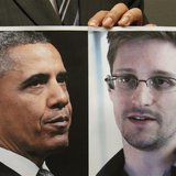 Pro-democracy lawamaker Gary Fan holds a combination photo featuring U.S. President Barack Obama (L) and Edward Snowden, a contractor at the Pro-democracy lawamaker Gary Fan holds a combination photo featuring U.S. President Barack Obama (L) and Edward Snowden, a contractor at the