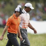 Northern Ireland's Rory McIlroy (L) and Tiger Woods of the U.S. walk together on the 10th fairway during the second round of the 2013 U.S. O