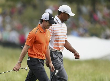 Northern Ireland's Rory McIlroy (L) and Tiger Woods of the U.S. walk together on the 10th fairway during the second round of the 2013 U.S. O Northern Ireland's Rory McIlroy (L) and Tiger Woods of the U.S. walk together on the 10th fairway during the second round of the 2013 U.S. O
