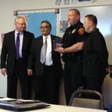 Gateway Association recognizes Sheboygan Police with flag and plaque.