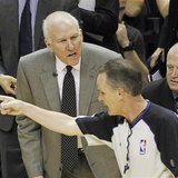 San Antonio Spurs head coach Gregg Popovich (L) questions a foul call during thrid quarter play against the Miami Heat in Game 4 of their NB