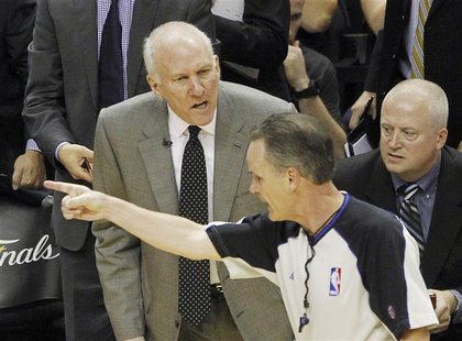 San Antonio Spurs head coach Gregg Popovich (L) questions a foul call during thrid quarter play against the Miami Heat in Game 4 of their NB San Antonio Spurs head coach Gregg Popovich (L) questions a foul call during thrid quarter play against the Miami Heat in Game 4 of their NB