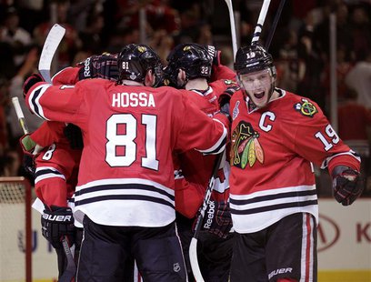 Chicago Blackhawks center Jonathan Toews (19) celebrates with his team after they defeated the Boston Bruins in triple-overtime in Game 1 of Chicago Blackhawks center Jonathan Toews (19) celebrates with his team after they defeated the Boston Bruins in triple-overtime in Game 1 of