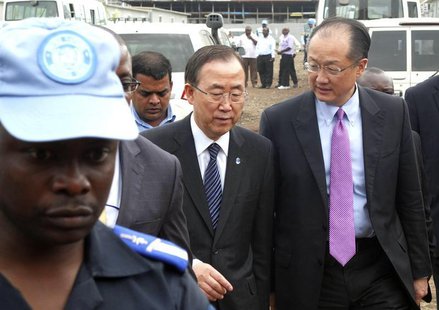 A U.N. peacekeeper escorts U.N. Secretary-General Ban Ki-moon and World Bank President Jim Yong Kim (R) during their joint trip to Goma, in A U.N. peacekeeper escorts U.N. Secretary-General Ban Ki-moon and World Bank President Jim Yong Kim (R) during their joint trip to Goma, in