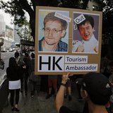 A protester supporting Edward Snowden, a former contractor at the National Security Agency (NSA), holds a placard showing pictures of Snowde