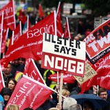Protesters wave placards and flags during an anti-G8 demonstration ahead of the summit, at Belfast City Centre June 15, 2013. REUTERS/Cathal