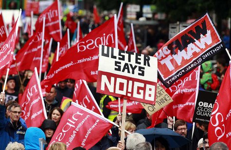 Protesters wave placards and flags during an anti-G8 demonstration ahead of the summit, at Belfast City Centre June 15, 2013. REUTERS/Cathal Protesters wave placards and flags during an anti-G8 demonstration ahead of the summit, at Belfast City Centre June 15, 2013. REUTERS/Cathal