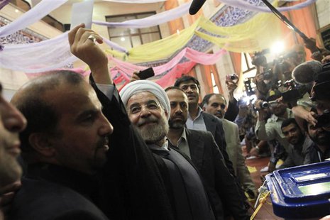 Presidential candidate Hassan Rohani shows his ballot before casting it during the Iranian presidential election in Tehran June 14, 2013. RE Presidential candidate Hassan Rohani shows his ballot before casting it during the Iranian presidential election in Tehran June 14, 2013. RE