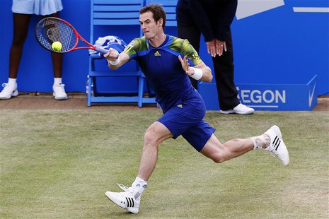 Britain's Andy Murray hits a return to France's Jo-Wilfried Tsonga during their men's singles semi-final tennis match at the Queen's Club Ch Britain's Andy Murray hits a return to France's Jo-Wilfried Tsonga during their men's singles semi-final tennis match at the Queen's Club Ch
