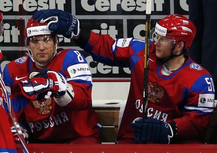 Russia's Alexander Ovechkin (L) gets a pat on the head by teammate Sergei Soin after judges validated his goal against Team USA during their Russia's Alexander Ovechkin (L) gets a pat on the head by teammate Sergei Soin after judges validated his goal against Team USA during their