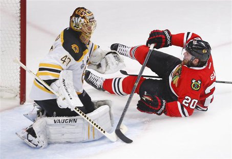 Chicago Blackhawks' Brandon Saad (R) slides into the net behind Boston Bruins goalie Tuukka Rask during the sceond period in Game 2 of their Chicago Blackhawks' Brandon Saad (R) slides into the net behind Boston Bruins goalie Tuukka Rask during the sceond period in Game 2 of their
