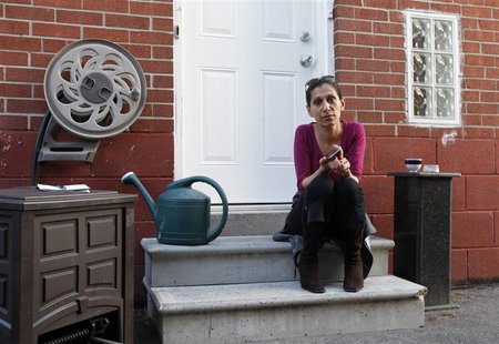 Viktoria Mohacsi sits at the door of the house, where she rents the basement apartment, in Toronto, May 9, 2013. REUTERS/Mirjam Donath Viktoria Mohacsi sits at the door of the house, where she rents the basement apartment, in Toronto, May 9, 2013. REUTERS/Mirjam Donath