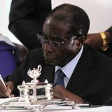 Zimbabwe President Robert Mugabe signs Zimbabwe's new constitution into law in the capital Harare, replacing a 33-year-old document forged i Zimbabwe President Robert Mugabe signs Zimbabwe's new constitution into law in the capital Harare, replacing a 33-year-old document forged i