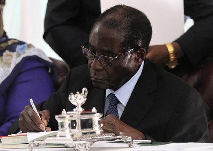 Zimbabwe President Robert Mugabe signs Zimbabwe's new constitution into law in the capital Harare, replacing a 33-year-old document forged i Zimbabwe President Robert Mugabe signs Zimbabwe's new constitution into law in the capital Harare, replacing a 33-year-old document forged i