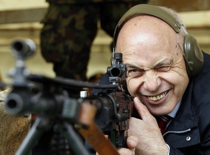 Swiss President Ueli Maurer aims at a target at 300 metres (984.25 feet) distance during a shooting exercise together with the Foreign Diplo Swiss President Ueli Maurer aims at a target at 300 metres (984.25 feet) distance during a shooting exercise together with the Foreign Diplo