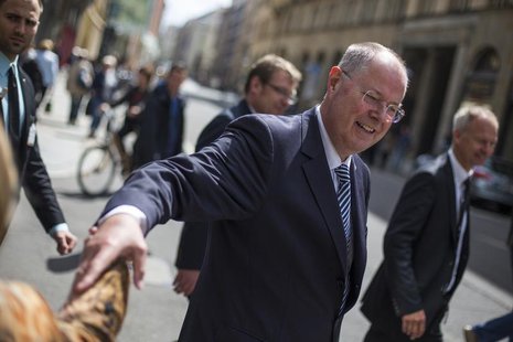 The top-candidate of the Social Democratic Party (SPD) in this year's German general election Peer Steinbrueck shakes hands with a passerby The top-candidate of the Social Democratic Party (SPD) in this year's German general election Peer Steinbrueck shakes hands with a passerby