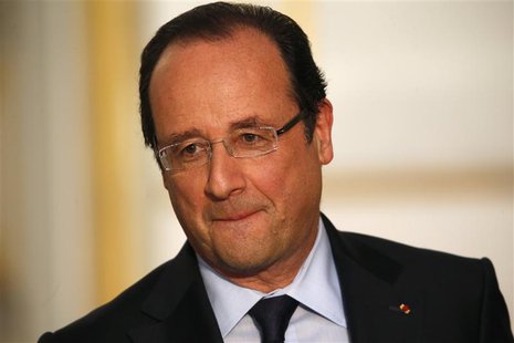 France's President Francois Hollande reacts during a joint news conference with Canada's Prime Minister Stephen Harper (not pictured) at the France's President Francois Hollande reacts during a joint news conference with Canada's Prime Minister Stephen Harper (not pictured) at the