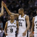 San Antonio Spurs' Tim Duncan (21) celebrates with teammates Danny Green (L), Tony Parker (9) and Boris Diaw (R) during the fourth quarter i
